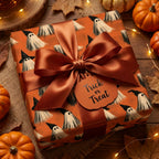 Orange ghost Halloween wrapping paper with a satin bow and Trick or Treat tag by Wrapped Studios.