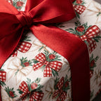 Vintage Christmas wrapping paper with gingham bows and a luxury red satin ribbon, by Wrapped Studios.