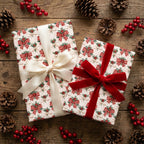 Christmas gift wrap with festive bows and red velvet ribbon on wood by Wrapped Studios.
