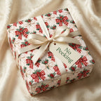 Vintage Christmas wrapping paper with red gingham bows and ivory ribbon by Wrapped Studios.
