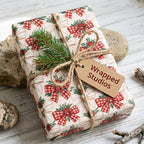 Rustic Christmas wrapping paper with red plaid bows and twine by Wrapped Studios.