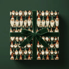 Vintage gnome Christmas wrapping paper with a green velvet bow on a gift box, by Wrapped Studios.