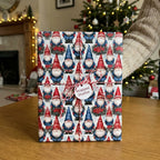 Gnome Christmas wrapping paper on a gift box with baker's twine by Wrapped Studios.