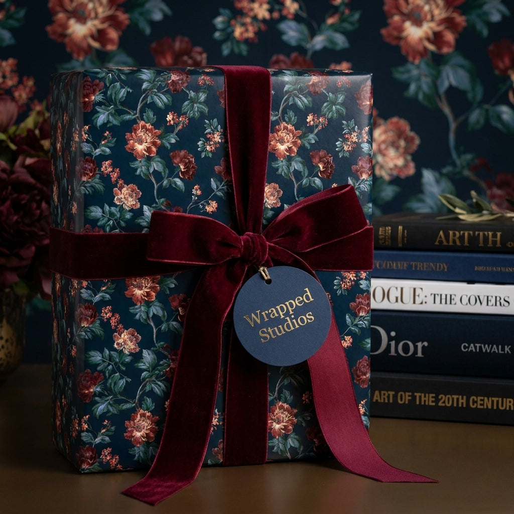 Luxury dark floral wrapping paper with burgundy velvet ribbon and tag by Wrapped Studios.