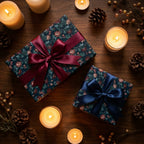 Vintage floral wrapping paper on luxury holiday gifts with satin bows and warm candles by Wrapped Studios.
