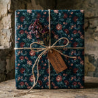 Dark vintage floral wrapping paper by Wrapped Studios on a gift tied with a rustic twine bow.