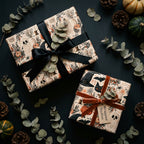 Vintage Halloween wrapping paper on gift boxes with luxury ribbons, pumpkins, and leaves by Wrapped Studios.