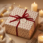 Cream luxury Christmas gift wrap with red velvet bow and tag by Wrapped Studios.