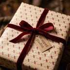 Luxury vintage wrapping paper with scroll pattern and red velvet bow by Wrapped Studios.