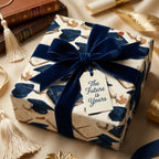 Luxury graduation wrapping paper with navy blue cap pattern and a velvet bow by Wrapped Studios.