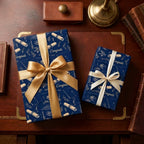 Navy blue graduation wrapping paper with luxury gold ribbons on a vintage desk by Wrapped Studios.