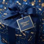 Luxury graduation wrapping paper in navy and gold with a matching bow and gift tag by Wrapped Studios.
