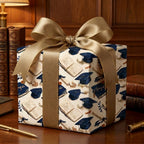 Graduation wrapping paper with navy caps, books, and a large gold satin bow by Wrapped Studios.