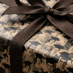 Graduation wrapping paper with vintage student photos and a textured brown ribbon by Wrapped Studios.
