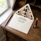 Vintage graduation wrapping paper used as an envelope liner on a wooden desk, by Wrapped Studios.