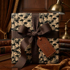 Graduation wrapping paper with vintage graduate pattern, brown bow, and leather tag by Wrapped Studios.