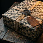 Vintage graduation wrapping paper with student photos, tied with twine and a wax seal, by Wrapped Studios.