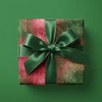 Luxury pink and green holiday wrapping paper with a dark green satin bow, Wrapped Studios.