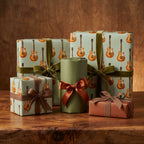 Vintage electric guitar wrapping paper with olive velvet ribbons on gift boxes by Wrapped Studios.
