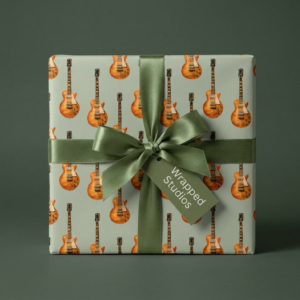 Guitar wrapping paper with electric guitars on sage green, with a satin green bow by Wrapped Studios.