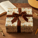 Gift wrapped in guitar-themed wrapping paper with brown velvet ribbon, perfect for a musician's birthday present.