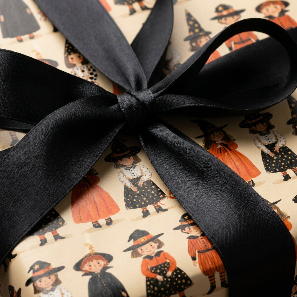 Vintage witch Halloween wrapping paper with a black satin bow by Wrapped Studios.