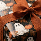 Spooky ghost and pumpkin Halloween wrapping paper with orange burlap ribbon by Wrapped Studios.