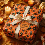 Spooky Halloween gift wrap with vintage orange monster pattern by Wrapped Studios, tied with a cream bow.