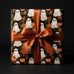 Halloween wrapping paper with cute ghosts and pumpkins, tied with an orange satin bow by Wrapped Studios.