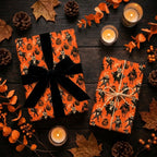Spooky orange Halloween wrapping paper with vintage monster illustrations and black velvet bow by Wrapped Studios.
