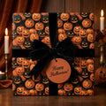 Vintage Halloween wrapping paper with jack-o'-lantern pattern and a black velvet bow by Wrapped Studios.