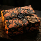 Spooky Halloween wrapping paper with jack-o'-lanterns, rustic twine, and wax seal by Wrapped Studios.