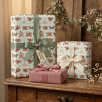 Vintage rose floral wrapping paper on gift boxes with green and cream ribbons by Wrapped Studios.