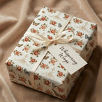 Luxury vintage floral wrapping paper with butterflies, cream ribbon, and a gift tag by Wrapped Studios.