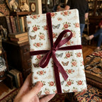Vintage floral wrapping paper with butterflies and burgundy velvet ribbon by Wrapped Studios.