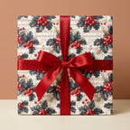 Vintage music sheet and holly Christmas wrapping paper with a red satin bow by Wrapped Studios.