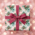 Vintage pink Christmas wrapping paper with a holly berry pattern and mauve bow, by Wrapped Studios.