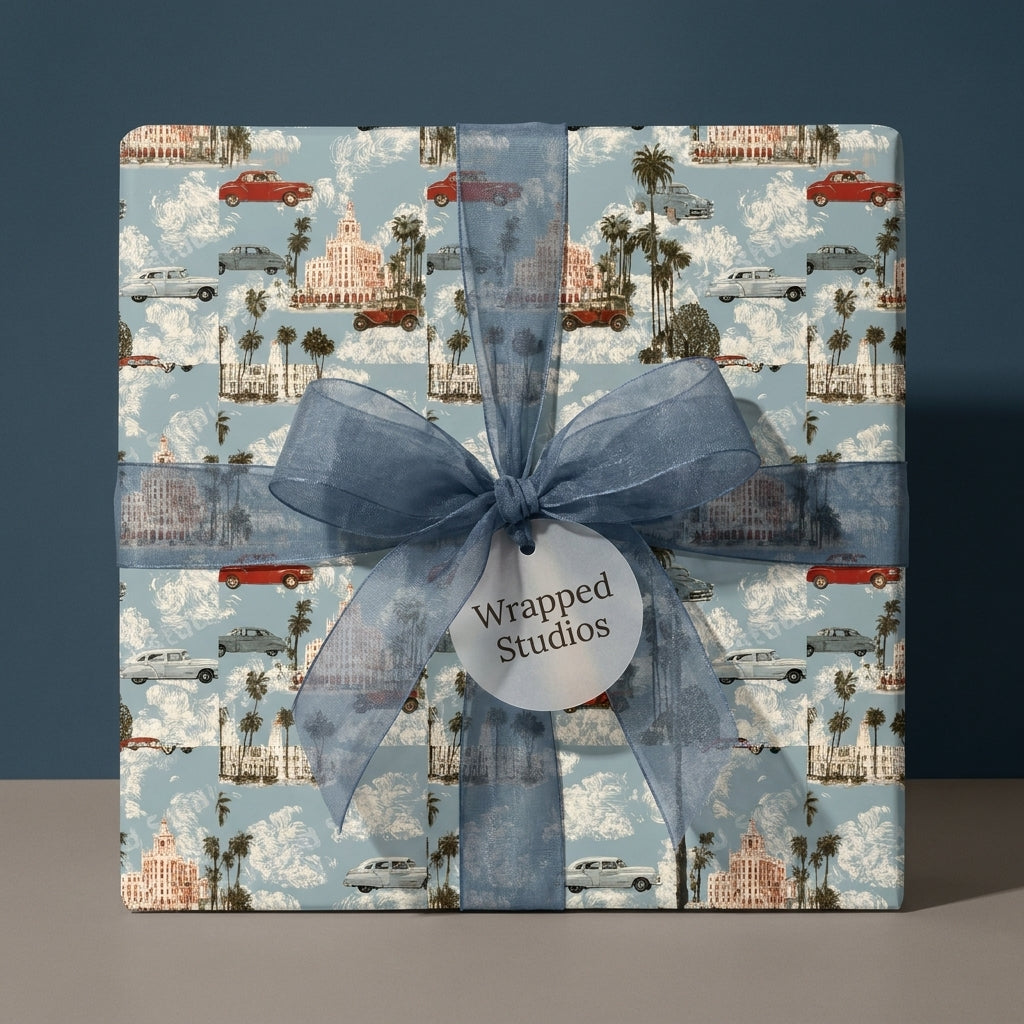 Vintage car wrapping paper with palm trees and a blue organza bow by Wrapped Studios.