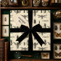 Beetle entomology wrapping paper with a black velvet ribbon and vintage specimen tag.