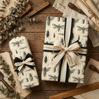 Rustic gift wrap: Gifts wrapped in insect print wrapping paper with ribbon on a wood surface.
