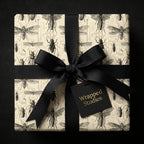 Vintage-style entomology wrapping paper with a black satin ribbon and bow.