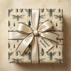 Gift wrapped in vintage entomology wrapping paper with a cream-colored satin ribbon and bow.