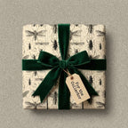 Unique entomology wrapping paper with emerald green velvet ribbon and a "For the Collector" tag.