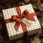 Gift box wrapped in insect pattern wrapping paper with rust-colored ribbon and "Specimen No. 1" tag.