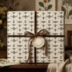 Gift wrapped in insect-themed wrapping paper with brown velvet ribbon and "Natural Curiosities" tag.