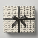 Gift wrapped in vintage-style entomology wrapping paper with a large gray satin bow.