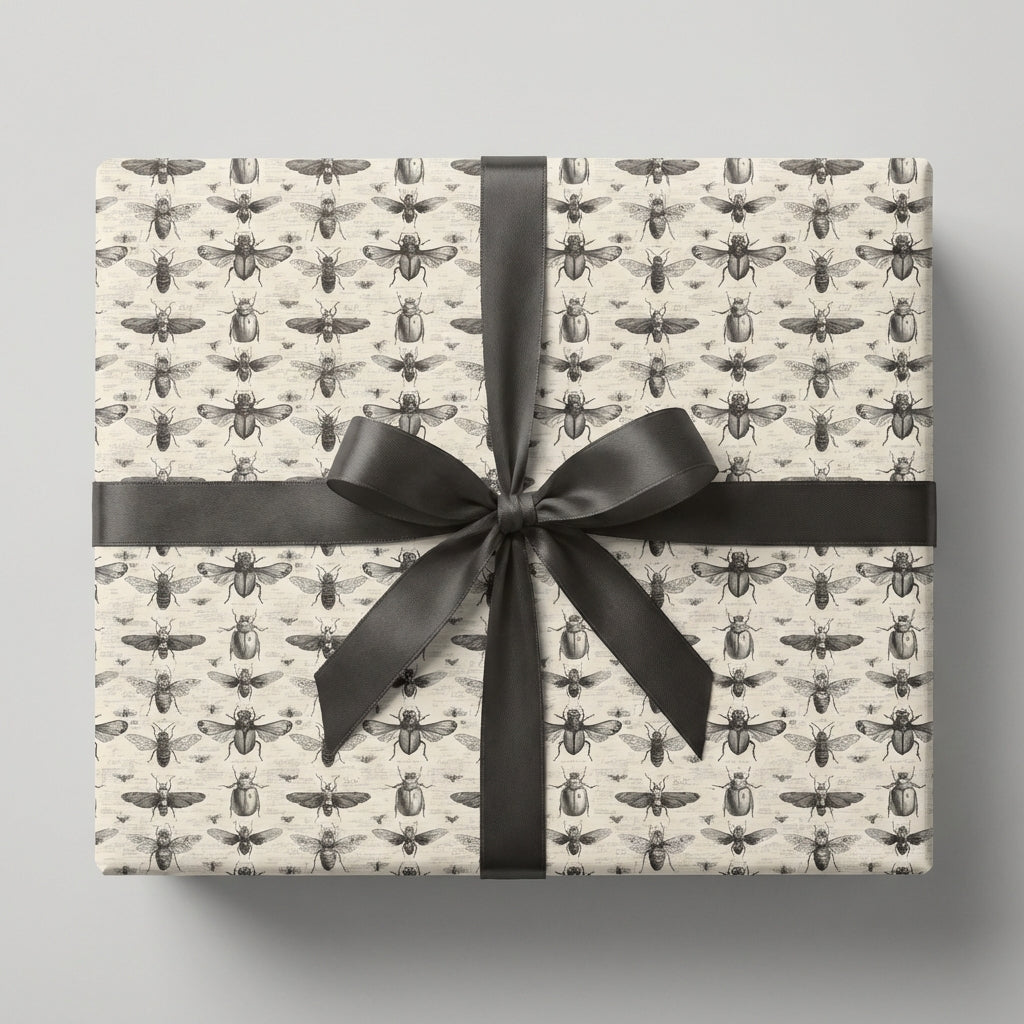 Gift wrapped in vintage-style entomology wrapping paper with a large gray satin bow.