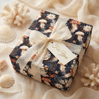 Luxury coastal wrapping paper with jellyfish design and cream bow by Wrapped Studios.