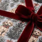 Puppy dog Christmas wrapping paper with a red velvet bow, luxury holiday gift wrap by Wrapped Studios.