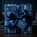 Navy blue library bookshelf wrapping paper with a luxury satin bow by Wrapped Studios.